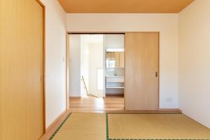 a hallway with a door and a rug at The villas Machidooya / Vacation STAY 35629 in Motobu