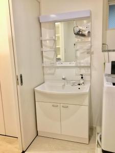 a bathroom with a sink and a mirror at A-style Futenma / Vacation STAY 35872 in Ginowan +15 photos