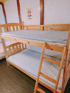 a bunk bed with a ladder in a room at Siｍple Stay Makishi / Vacation STAY 45013 in Naha +5 photos