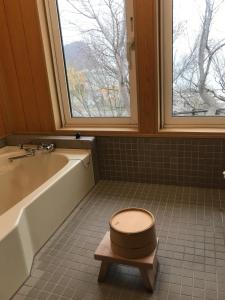 a bathroom with a toilet with a tub and a window at Yoichi-gun - House / Vacation STAY 43683 in Yoichi