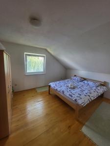 a bedroom with a bed in a room with a window at N&M Mountain Escape in Kupres +3 photos
