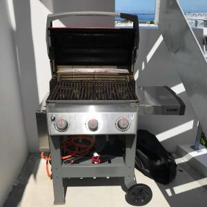 a grill sitting on a stand in a balcony at Nakagami-gun - House / Vacation STAY 45165 in Yomitan