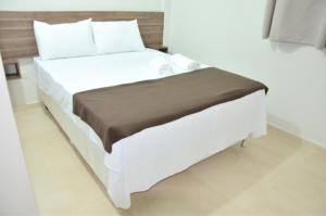Voodi või voodid majutusasutuse Hotel Sur Brasil toas