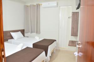 Voodi või voodid majutusasutuse Hotel Sur Brasil toas