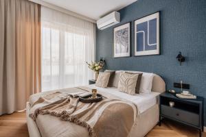a bedroom with a large bed and a window at Electra Apartments in Krakow