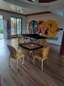 a room with a ping pong table and chairs at Sandalwoods Resort in Neral