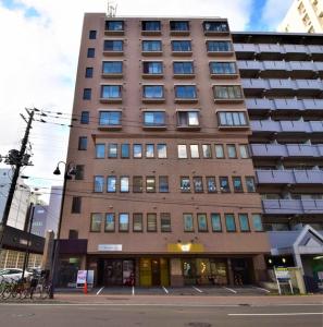 a tall building on the corner of a street at E-Horizon North 2 Building / Vacation STAY 4752 in Sapporo