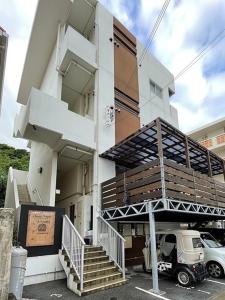 a building with stairs and a truck parked in front of it at i home Tsubogawa - Vacation STAY 16570v in Naha