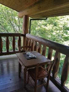 a wooden table and chairs on the porch of a cabin at Ryoshuku Lassi / Vacation STAY 47925 in Koga