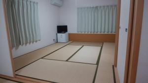 an empty room with a door and a television at Hidaka-gun - House - Vacation STAY 99266v in Haneda