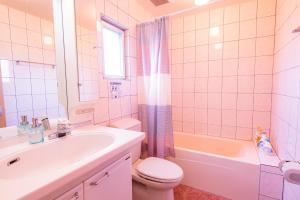 a bathroom with a sink and a toilet and a tub at Kunigami-gun - House / Vacation STAY 53153 in Atsutabaru +61 photos