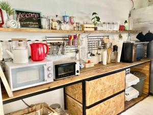 a kitchen with two microwaves and a microwave on a counter at Fukuoka - House / Vacation STAY 4898 in Fukuoka