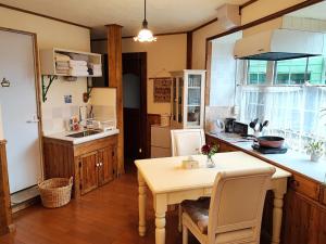a kitchen with a table and a table and chairs at Eniwa - House - Vacation STAY 18354 in Eniwa