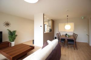 a living room with a couch and a table at HOPE VILLA Onna-son - Vacation STAY 52848 in Inbu