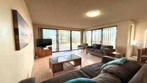 a living room with a couch and a tv at Flinders Lodge 4, 4 - 22 Clarence St in Yamba