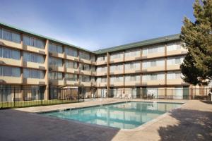 an apartment building with a swimming pool in front of it at Radisson Hotel Denver Central in Denver