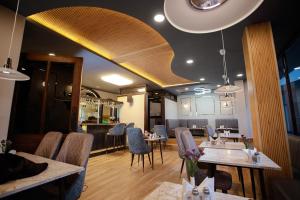 a restaurant with tables and chairs in a room at The Core in Kohīma