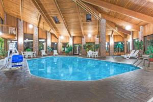 a large swimming pool in a building with a wooden ceiling at Baymont by Wyndham Smyrna in Atlanta