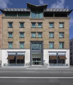 a large brick building with a store front at The Morrison Dublin, Curio Collection by Hilton in Dublin