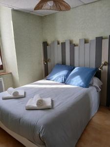 a bedroom with a large bed with towels on it at Le Som' des Pyrénées in Luz-Saint-Sauveur +10 photos
