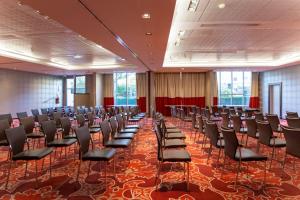 a large room with rows of chairs in it at Clarion Paris CDG Airport in Roissy-en-France +106 photos