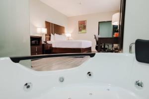 a bathroom with a tub in a hotel room at Comfort Inn & Suites Tobago in Tobago Island