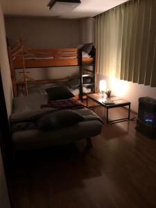 a bedroom with a bunk bed and a table at NY Building 4th Floor, Guest House Ichibangai, Roo / Vacation STAY 55905 in Kitami