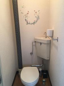 a small bathroom with a toilet and a shower at Utopia Wakamiya 207 / Vacation STAY 5372 in Fukuoka +10 photos