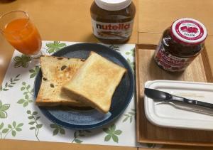 a plate with two slices of toast on a table at Otaru - House / Vacation STAY 57190 in Otaru +15 photos