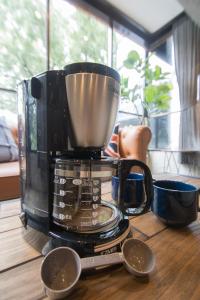 a coffee maker sitting on top of a wooden table at ARK NISHIJIN 2 / Vacation STAY 57345 in Fukuoka