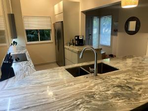 a kitchen with a sink and a counter top at Waikoloa Beach Condo in Waikoloa +18 photos