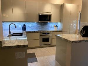 a kitchen with a sink and a counter top at Waikoloa Beach Condo in Waikoloa