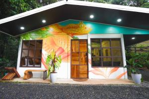 a small house with a fish painted on it at Coco Cabana in the Jungle in Sarapiquí