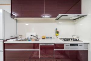 a kitchen with a sink and a counter top at Travel Palace Miyuki "Yomiuri Shimbun" - Vacation STAY 10239 in Kawaguchi