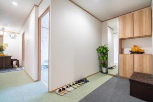 a room with a wall with shoes on the floor at Travel Palace Miyuki "Yomiuri Shimbun" - Vacation STAY 10240 in Kawaguchi