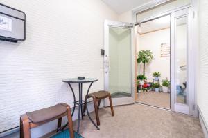 a room with a table and two chairs and a door at Travel Palace Miyuki (Yomiuri Shimbun) / Vacation STAY 5734 in Kawaguchi