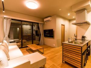 ein Wohnzimmer mit Sofa und Tisch in der Unterkunft Rakuten STAY MOTEL Kujukurihama Katakai 104 2LDK with BBQ terrace Garage concept room in Kujukuri