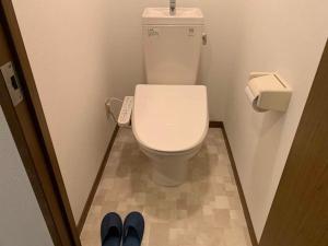 a bathroom with a toilet with a remote control at AO Dazaifu / Vacation STAY 61719 in Chikushino +12 photos