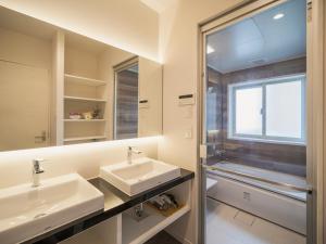 a bathroom with two sinks and a mirror at Naha - House / Vacation STAY 60932 in Naha +70 photos