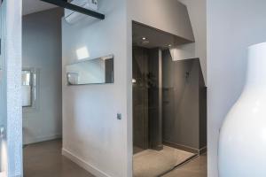 a hallway with a glass door in a room at Fresh Modern Suite, Close To City Hotspots in Oss +33 photos