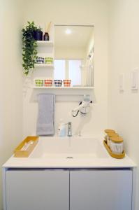 a white bathroom with a sink and a mirror at Nagasaki - House / Vacation STAY 63873 in Nagasaki