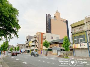 a city street with buildings and cars on the road at Petit Hotel 017 / Vacation STAY 67155 in Tokushima