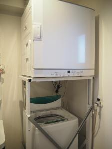 a bathroom with a toilet with a shelf above it at Sea Turtle / Vacation STAY 5694 in Miyako Island