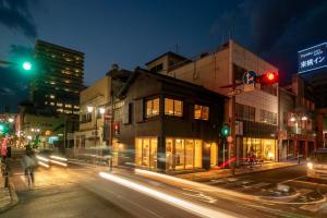 a city street at night with traffic lights and buildings at Ebisuya / Vacation STAY 5850 in Kofu