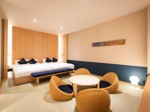 Postel nebo postele na pokoji v ubytování FIRSTCABIN Kyoto Nijojo