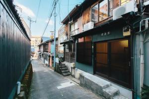 a narrow alley with buildings on a city street at Nagasaki - House / Vacation STAY 70083 in Nagasaki