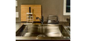 a kitchen with a stainless steel sink and drying rack at Rakuten STAY HOUSE x WILL STYLE Fujinomiya 101 in Fujinomiya +31 photos