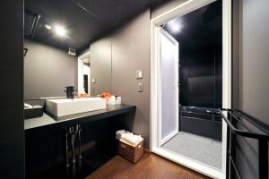 a bathroom with a sink and a large mirror at Rakuten STAY x EAGLES 201 with Roof balcony in Sendai