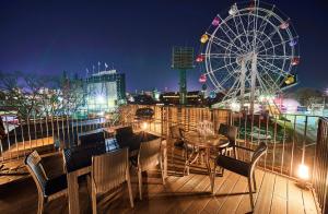 a view of a ferris wheel and a table and chairs at Rakuten STAY x EAGLES 201 with Roof balcony in Sendai