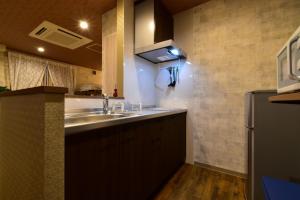 eine Küche mit Spüle und Kühlschrank in der Unterkunft Center Kamei-cho / Vacation STAY 75207 in Takamatsu + 9 Fotos